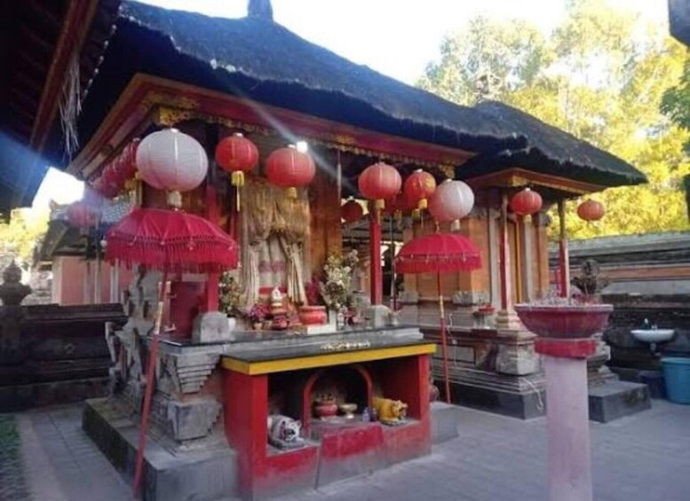 A traditional temple with red lanterns and a small altar. 4