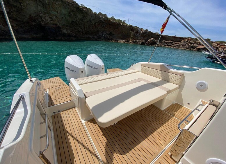 A boat with a wooden deck and two Mercury outboard motors. 3