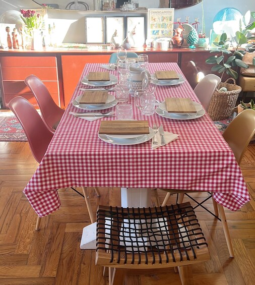 A dining table set with plates, glasses, and a checkered tablecloth. 3