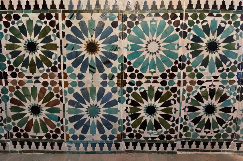 A wall with intricate geometric tile patterns. 2