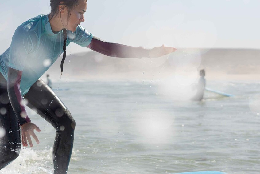 A person surfing on a wave with ocean spray visible. 5