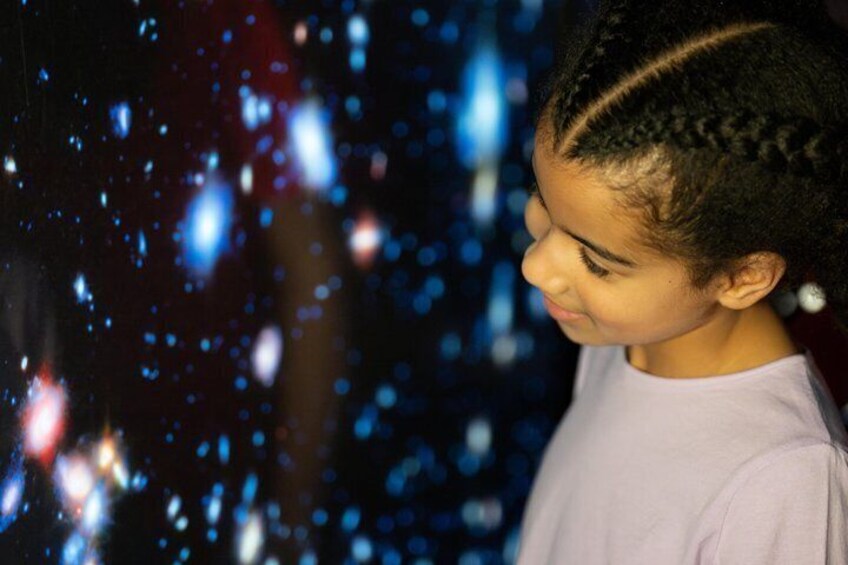 A child with braided hair and a light purple shirt. 5
