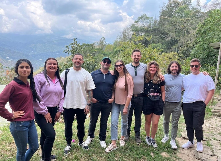 A group of people standing outdoors with a mountainous landscape in the background. 2