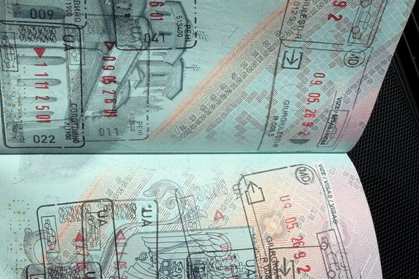 A passport with visible stamps and text, including dates and locations. 4