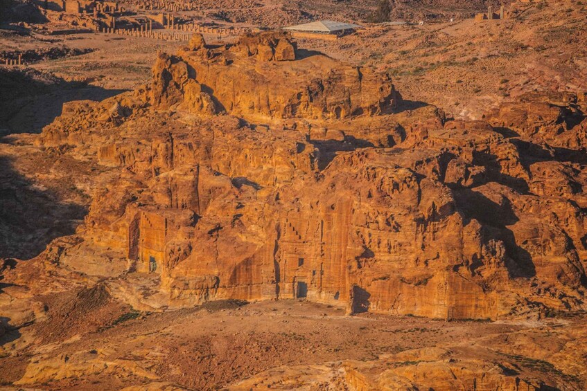 A rugged, rocky landscape with ancient ruins and a large, open area. 5