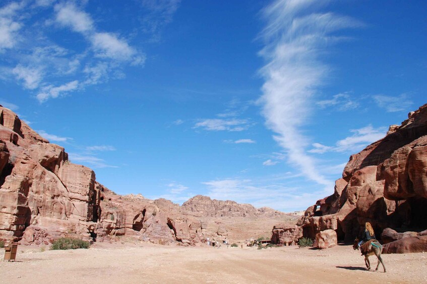 A desert landscape with red rock formations and a clear blue sky. 4