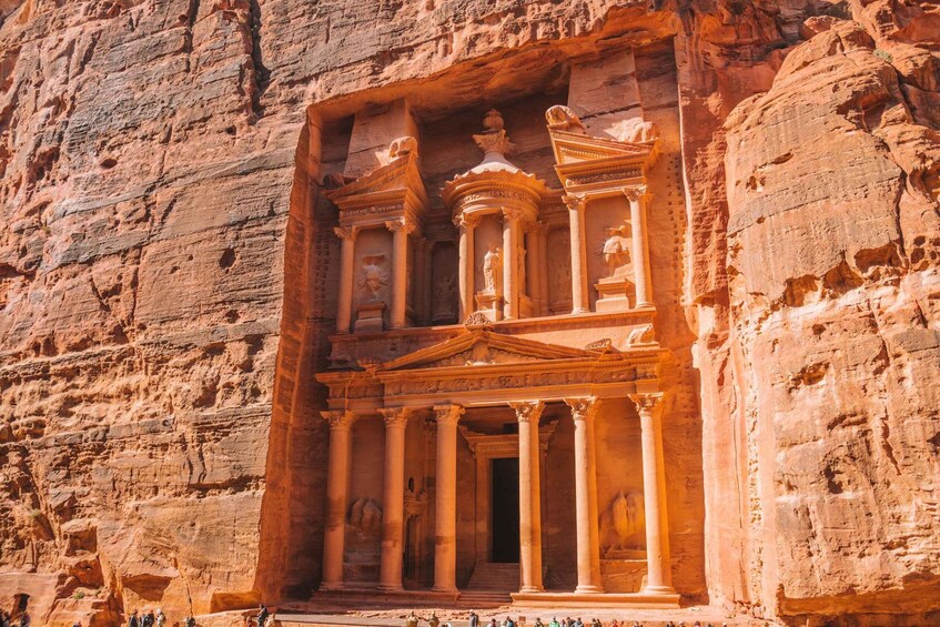 A rock-cut temple with columns and intricate carvings. 1