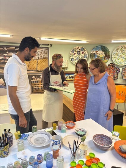 A pottery workshop with people engaged in crafting. 4