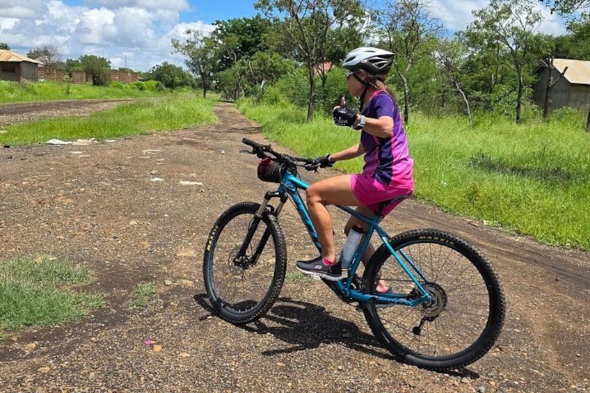 A person riding a mountain bike on a dirt path. 1