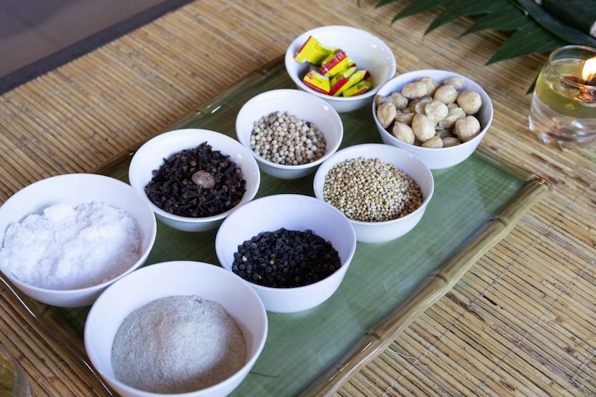 Bowls of various spices and grains on a bamboo mat. 2