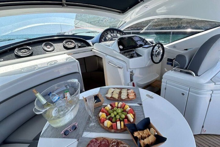A boat's interior with a table set with snacks and drinks. 5