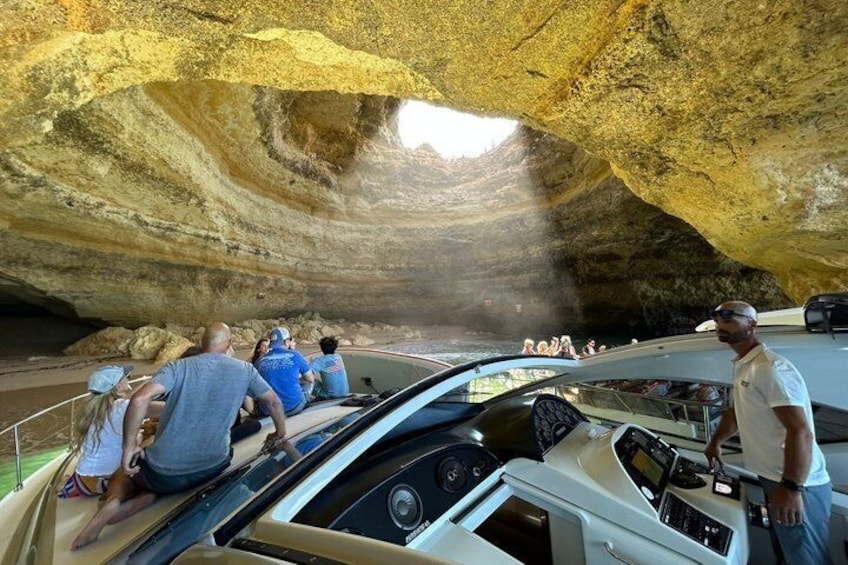 A boat with people inside a cave-like structure. 4
