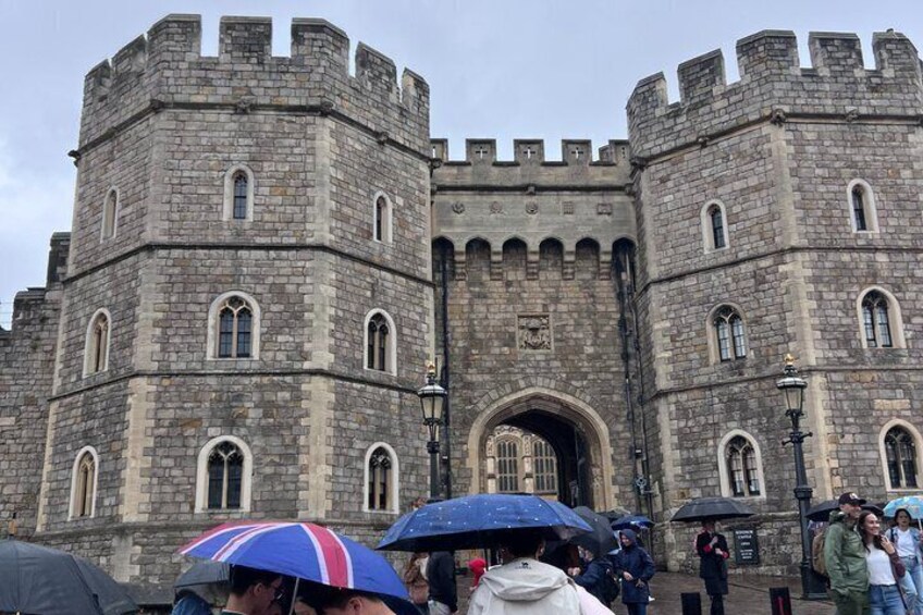 A historic stone castle with arched gateways and battlements. 1