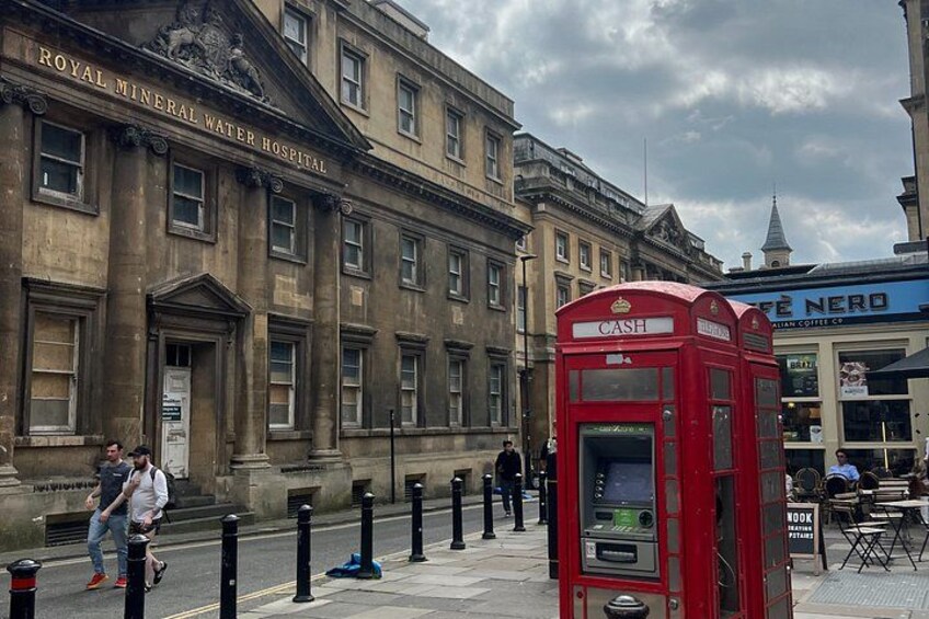 A red British telephone booth, a Royal Mineral Water Hospital building, and a coffee shop named 'Cafe Nero'. 5