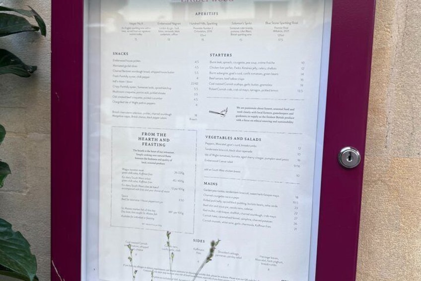 A menu board with categories like appetizers, snacks, starters, salads, mains, and sides. 4