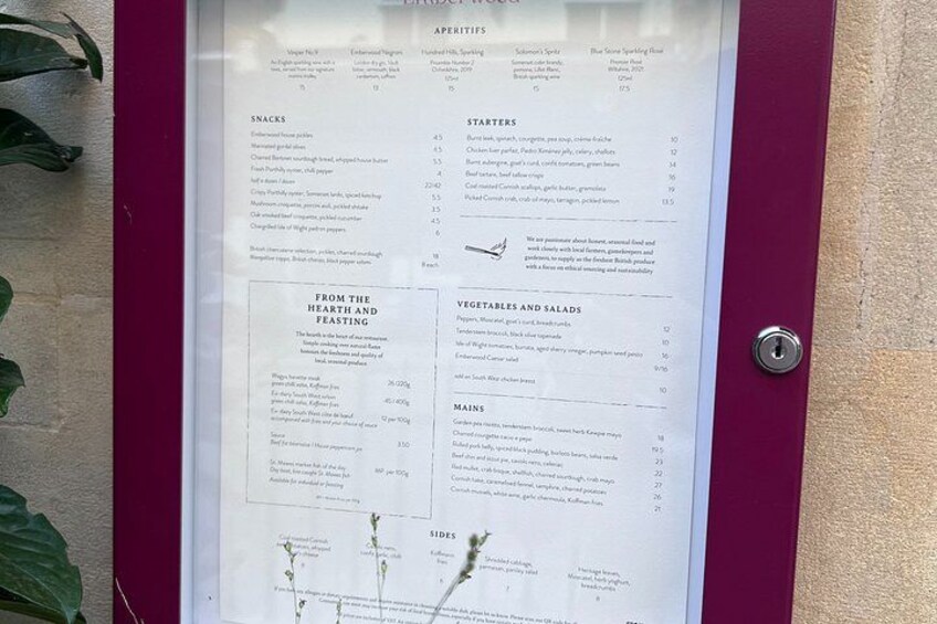 A menu board with sections for appetizers, snacks, starters, salads, mains, and sides. 4