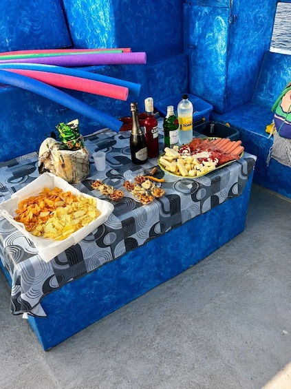 A table with snacks, drinks, and a bottle of champagne. 5