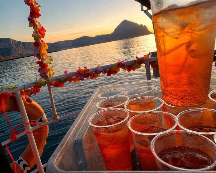 A beverage cart with drinks and a decorative garland on a boat. 2