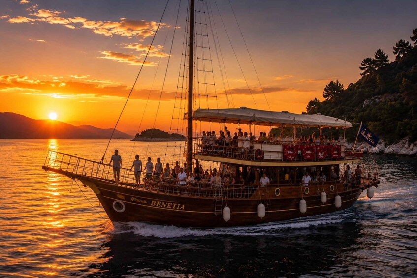 A wooden boat named 'BENETIA' with people on deck, sailing at sunset. 4
