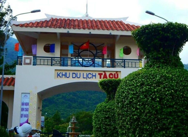 A traditional Vietnamese gate with the inscription 'KHU DU LIÊN TÀCÚ' and a decorative bicycle sculpture above it. 4