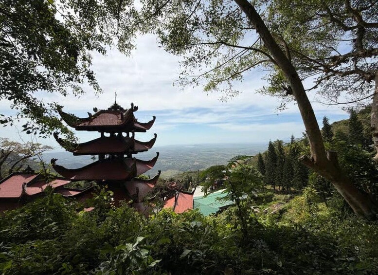 A pagoda surrounded by lush greenery and a distant view of a cityscape. 3