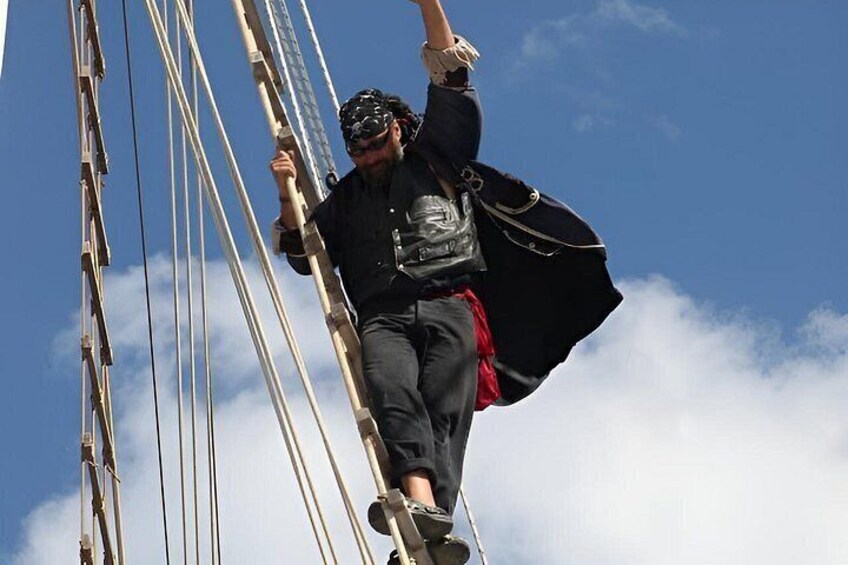 A person climbing a tall structure with ropes. 4