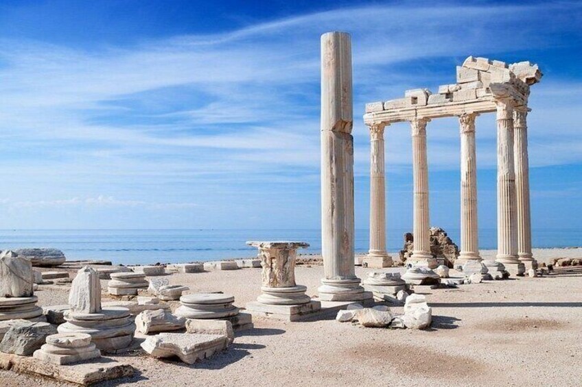 Ancient ruins with columns and scattered stone blocks. 2