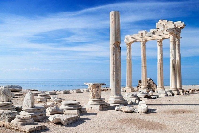Ancient ruins with columns and stone structures by the sea. 2