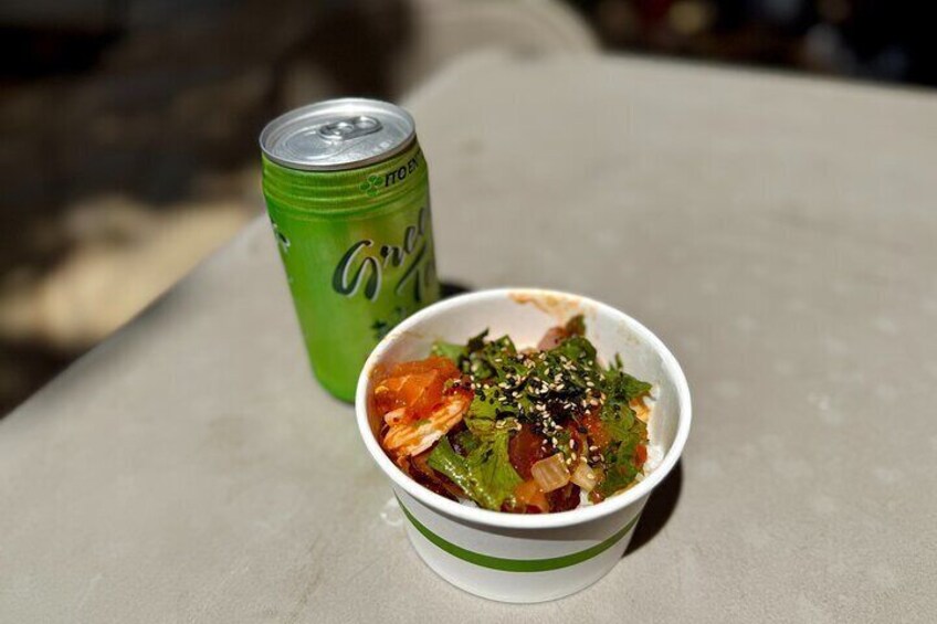 A bowl of food with a green can beside it. 5