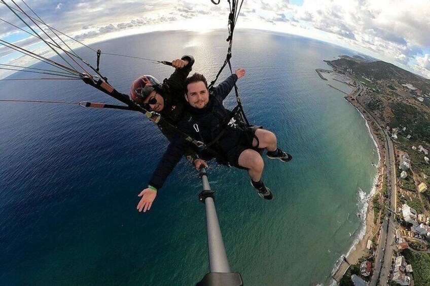 A person skydiving over a coastal area with a clear view of the ocean and a coastline. 3