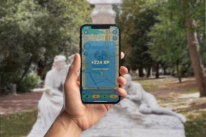 A hand holding a smartphone displaying a map with a notification of completed challenges. 3