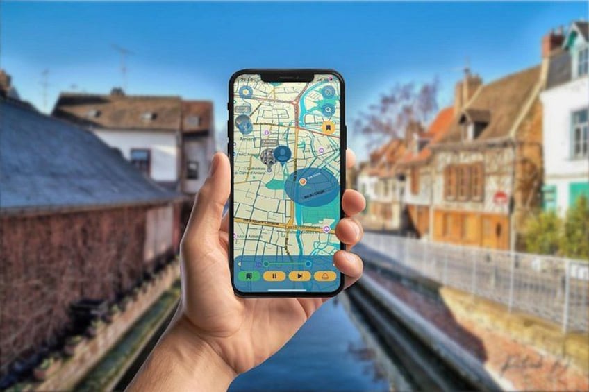 A hand holding a smartphone displaying a map with a river and buildings in the background. 2