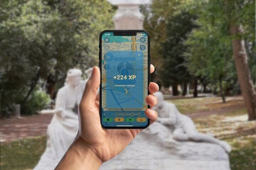 A hand holding a smartphone displaying a map with a notification of completed challenges. 4