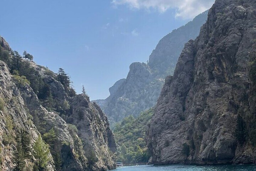 A canyon with steep cliffs and a river. 4