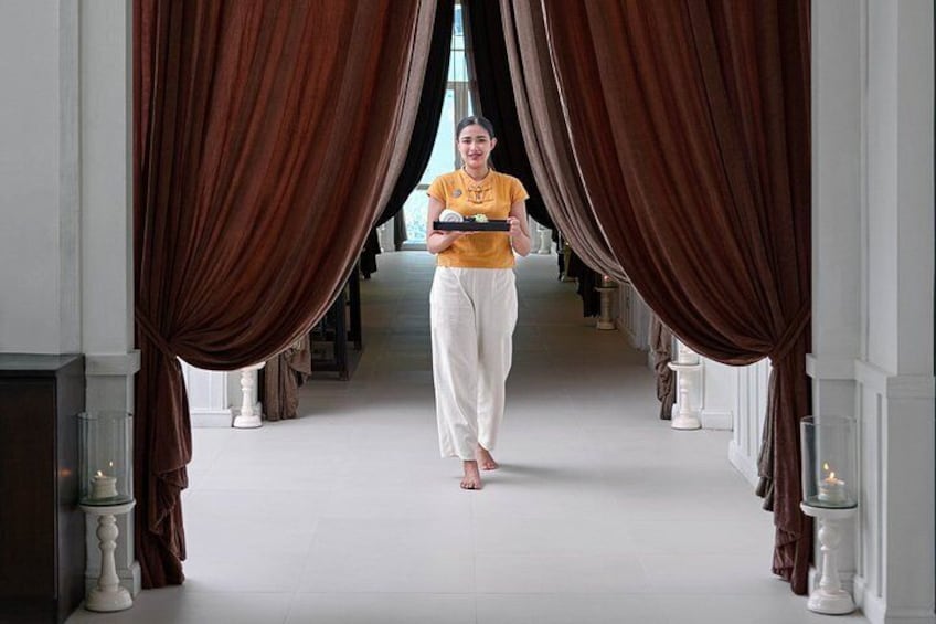 A person walking through a corridor with brown curtains on either side. 4
