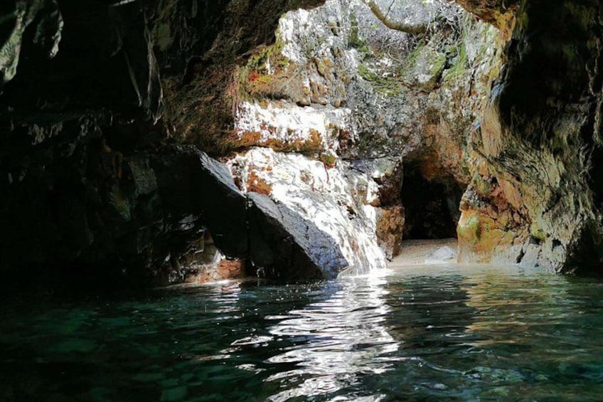A cave with a water pool and a natural archway. 2