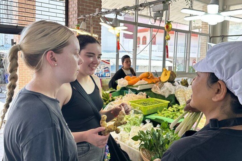 A market stall with fresh produce and a person in a chef's hat. 3