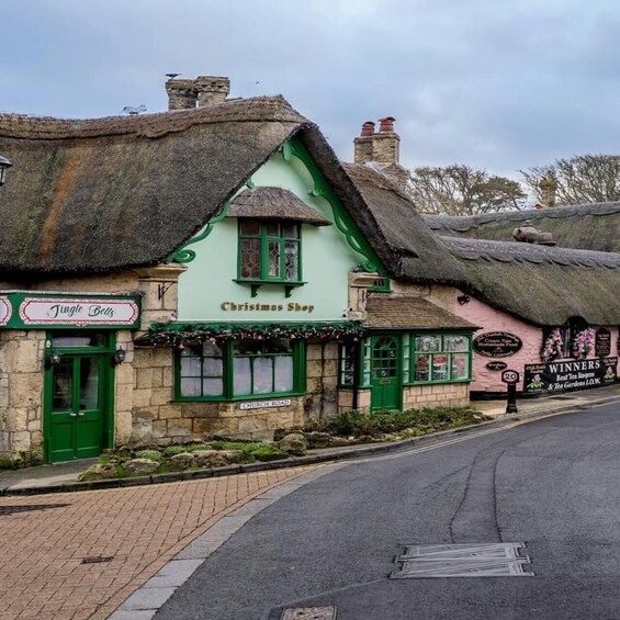 A traditional building with a green facade and a sign reading 'Christmas Shop.' 3