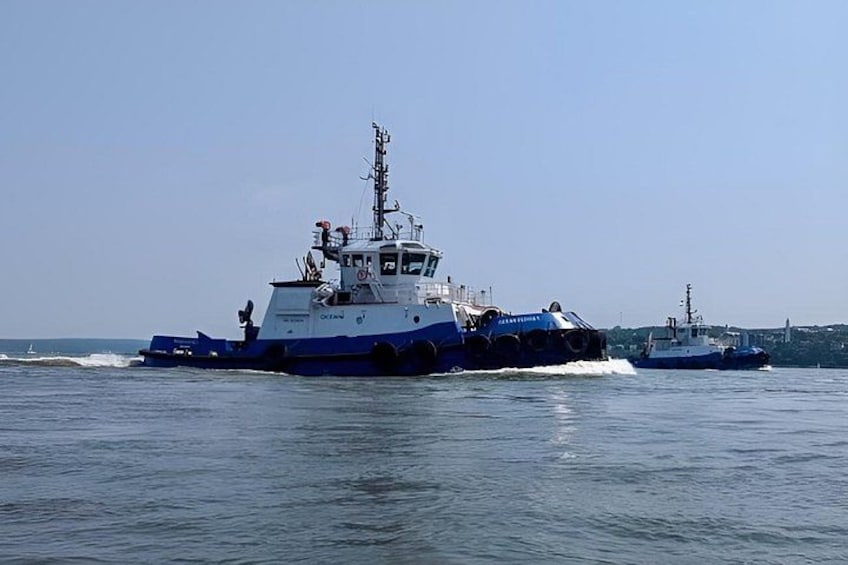 Two large blue and white ships on calm water. 3