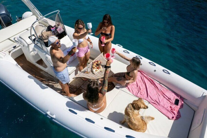A group of people on a boat with a dog, surrounded by water. 5