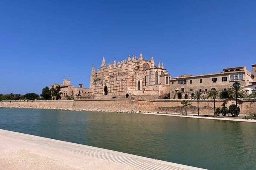 A historic building with intricate architecture by a calm river. 1