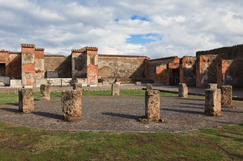 Ancient ruins with stone columns and brick structures. 3