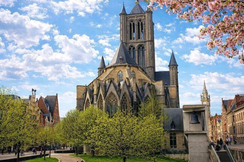A historic church with a tall bell tower, surrounded by trees and traditional buildings. 4