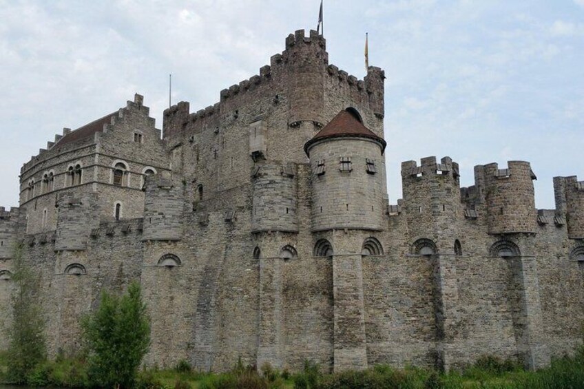 A historic stone castle with multiple towers and battlements. 4