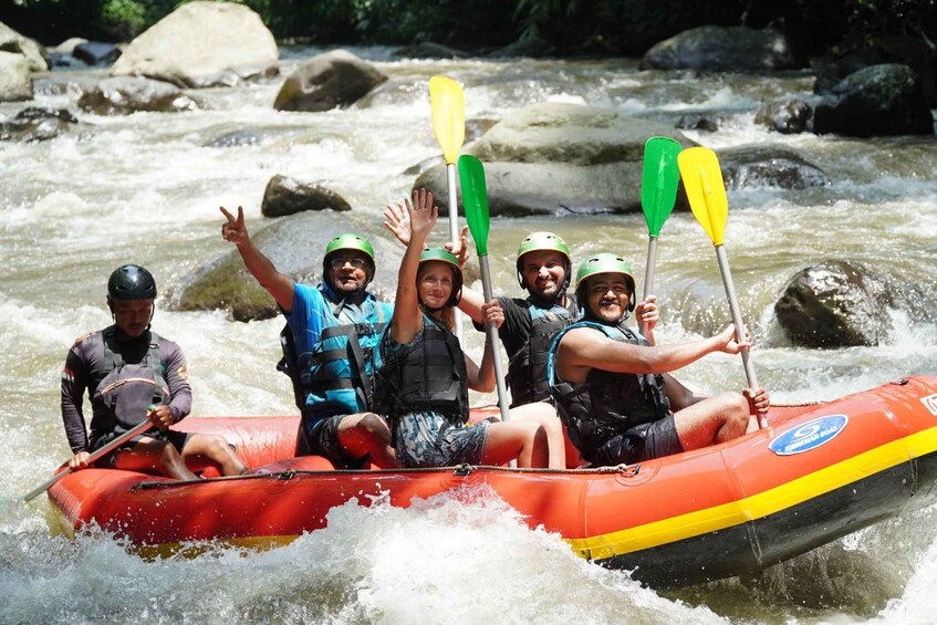 A group of people in a red inflatable raft on a river with rapids. 4