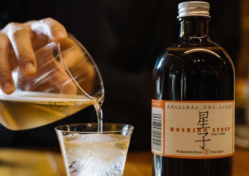A hand pouring liquid from a bottle into a glass. 2