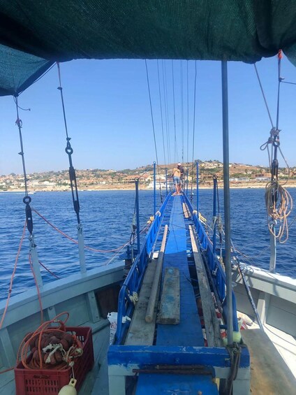 A boat deck with ropes and a person standing on the deck. 1