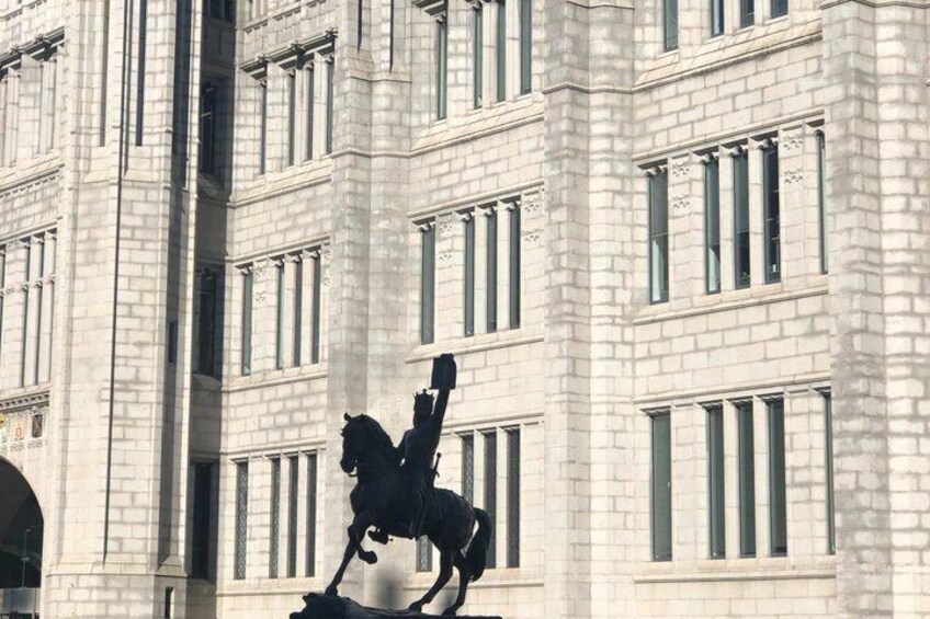 A building with a statue of a horse and rider. 2
