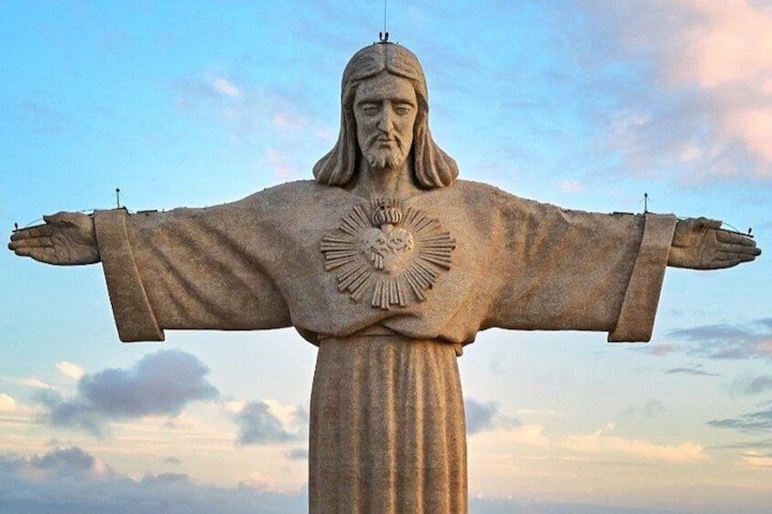 A large statue with outstretched arms and a heart-shaped design on the chest. 3
