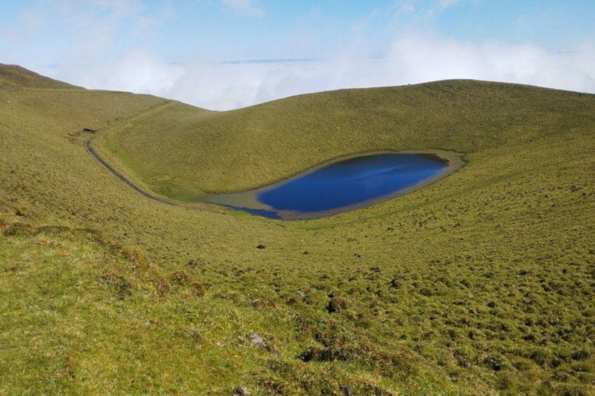 A hilly landscape with a small lake. 5